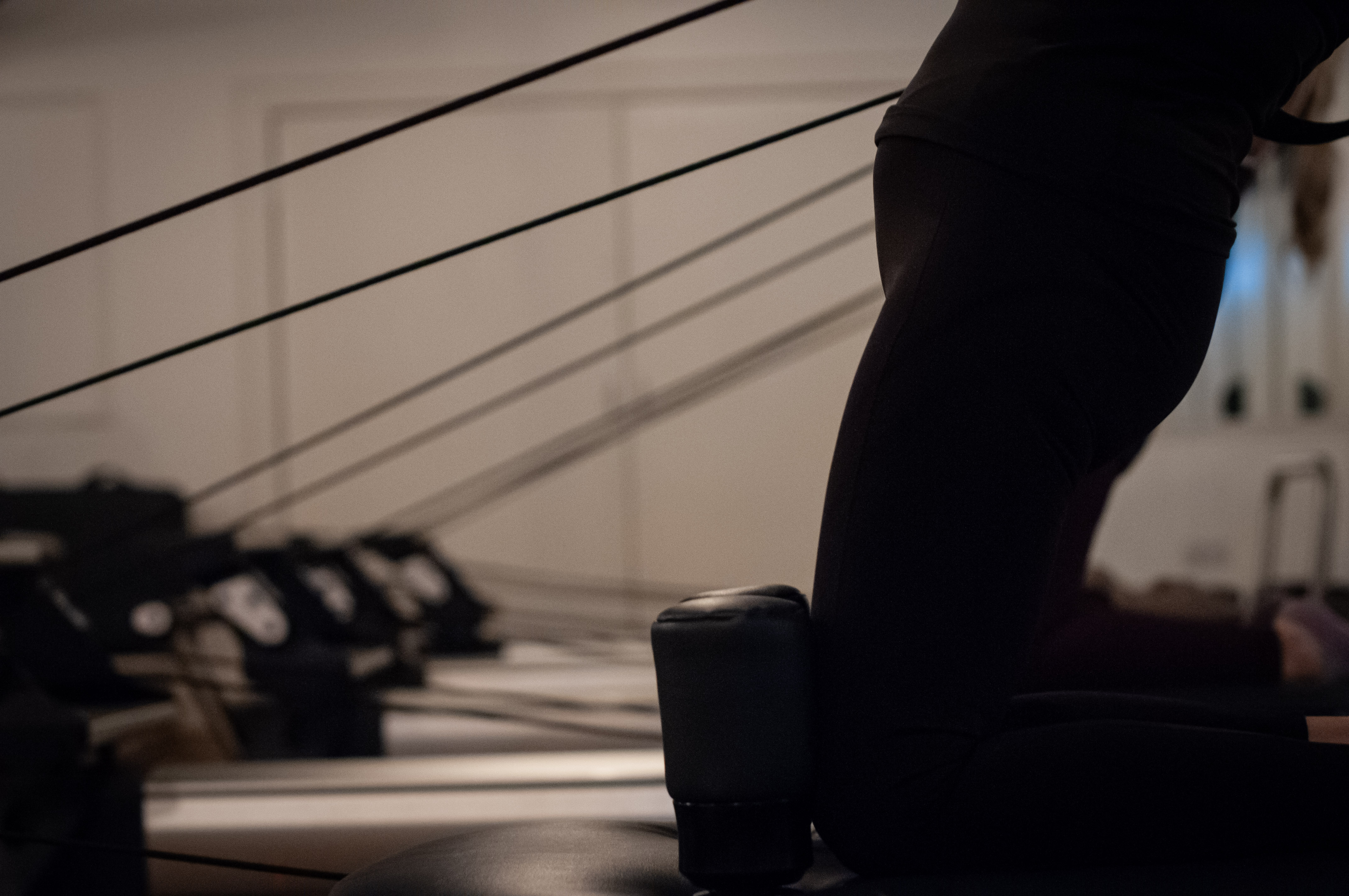 Reformer cables and springs stretched taut across the studio