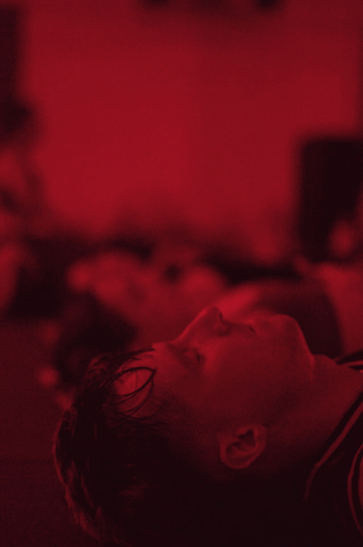 A man lying flat on his mat, catching his breath after the final set