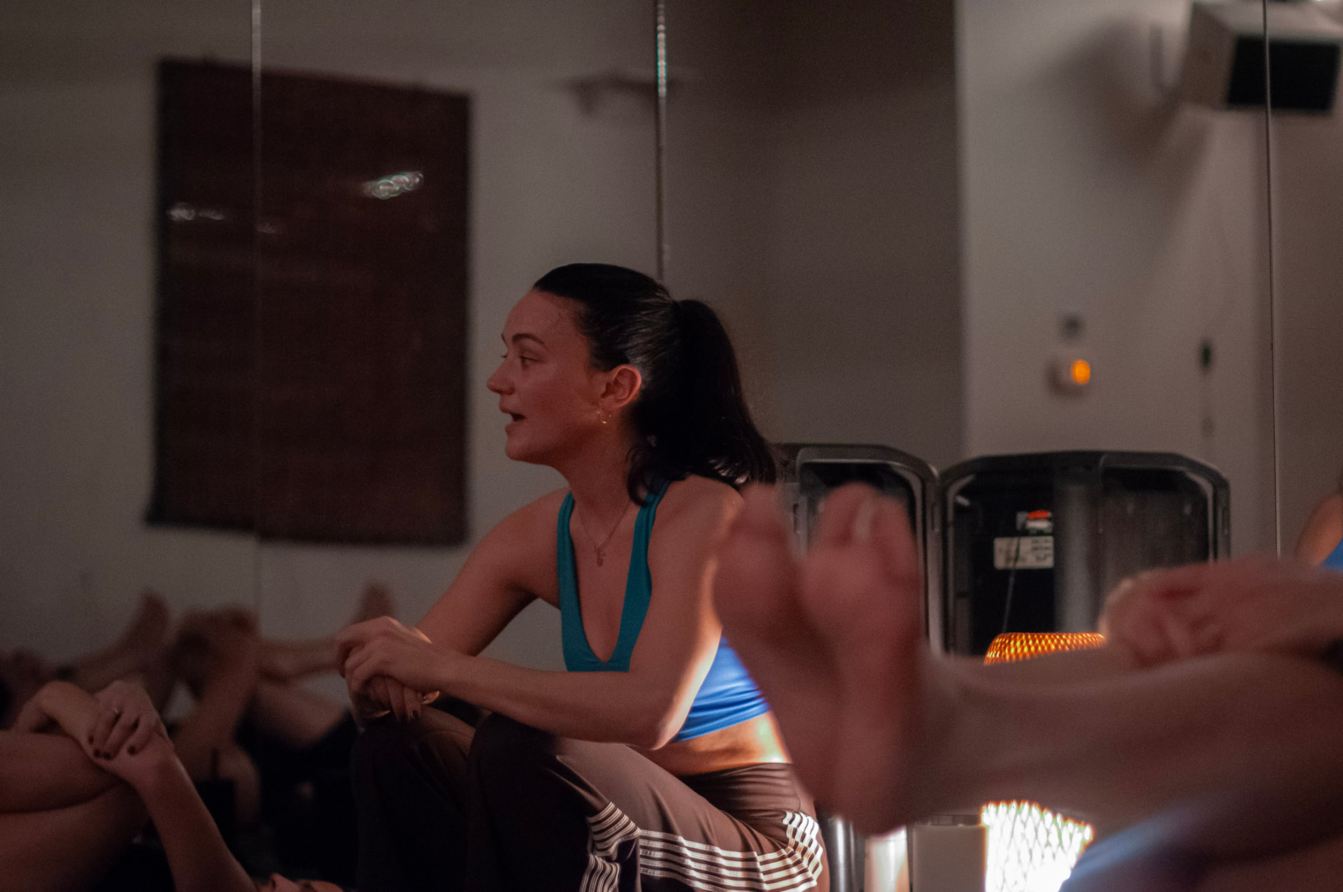 The instructor crouched beside a resting class, guiding them through the sequence