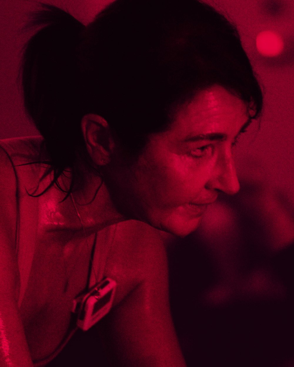 Sharon, Hot Yoga and Hot Pilates instructor, mid-class under red light in the Hot Pilates room