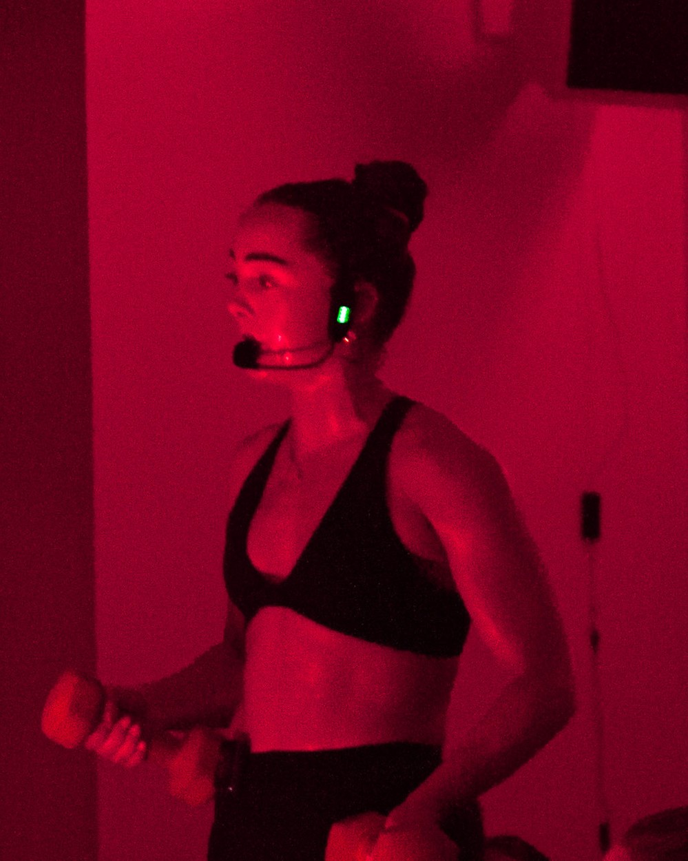 Maeve McC, Hot Pilates and Reformer instructor, coaching with a headset mic